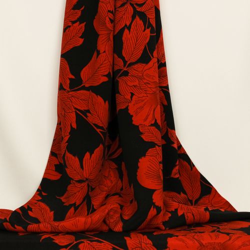 Lichte polyester crêpe zwart met rode bloemen