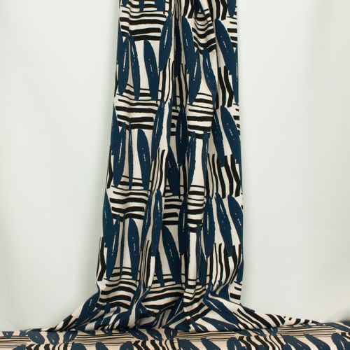 Ecru tricot met abstracte strepen in zwart en blauw