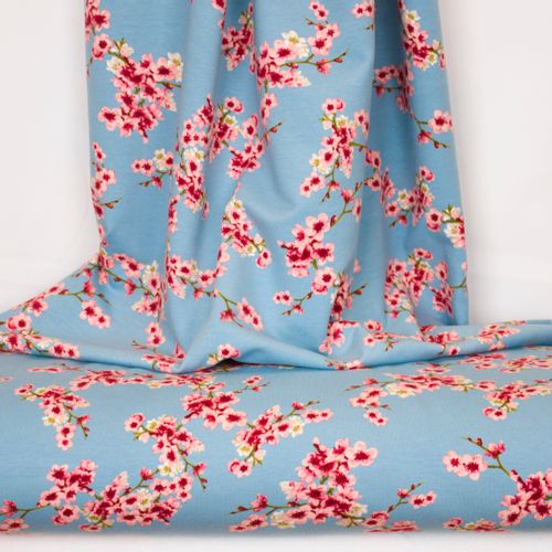 Blauwe sweaterstof met roze bloemen van Poppy