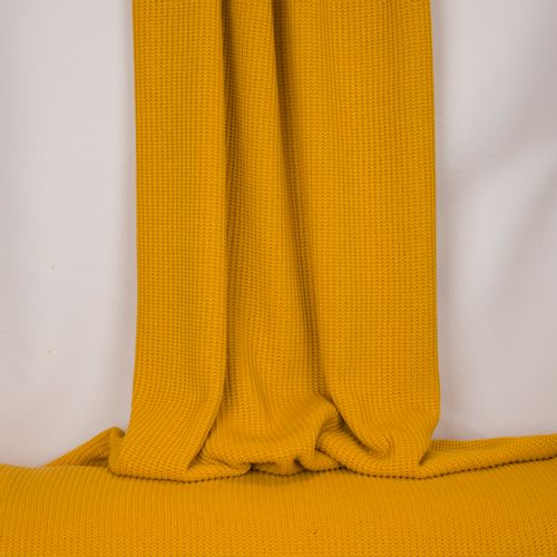 Gele gebreide stof in katoen / polyestermengeling