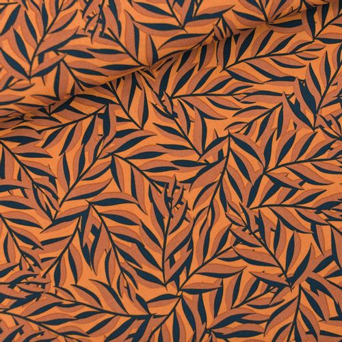 Viscose rayon "Leaves" van See You At Six,  bladmotief in oranje en zwarte tinten