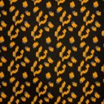 Metallic jersey zwart met oker luipaardprint