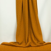 Okergele gebreide stof met kabelmotief