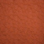Roestkleurige  viscose structuurtricot met een fijn bloemetjes motiefje