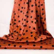 Gesatineerde polyester jacquard stretch oranje met zwarte stippen