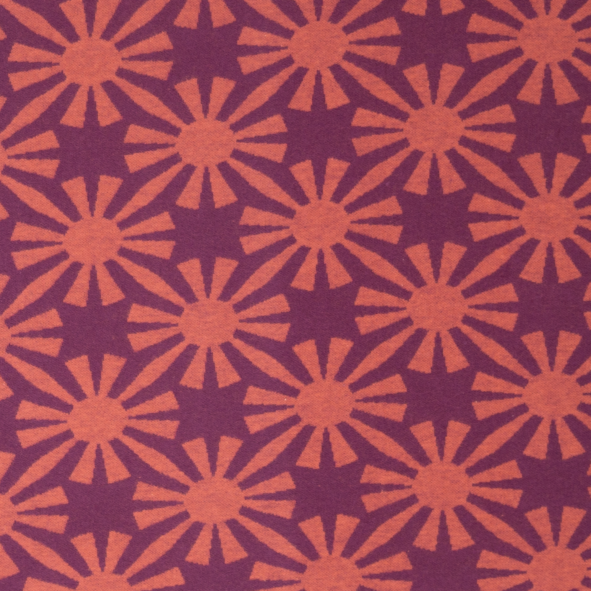 Jacquard tricot donkerroos met zonnen motief