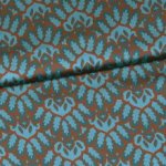 Polyester satijn turquoise met retromotief met bruine omlijning