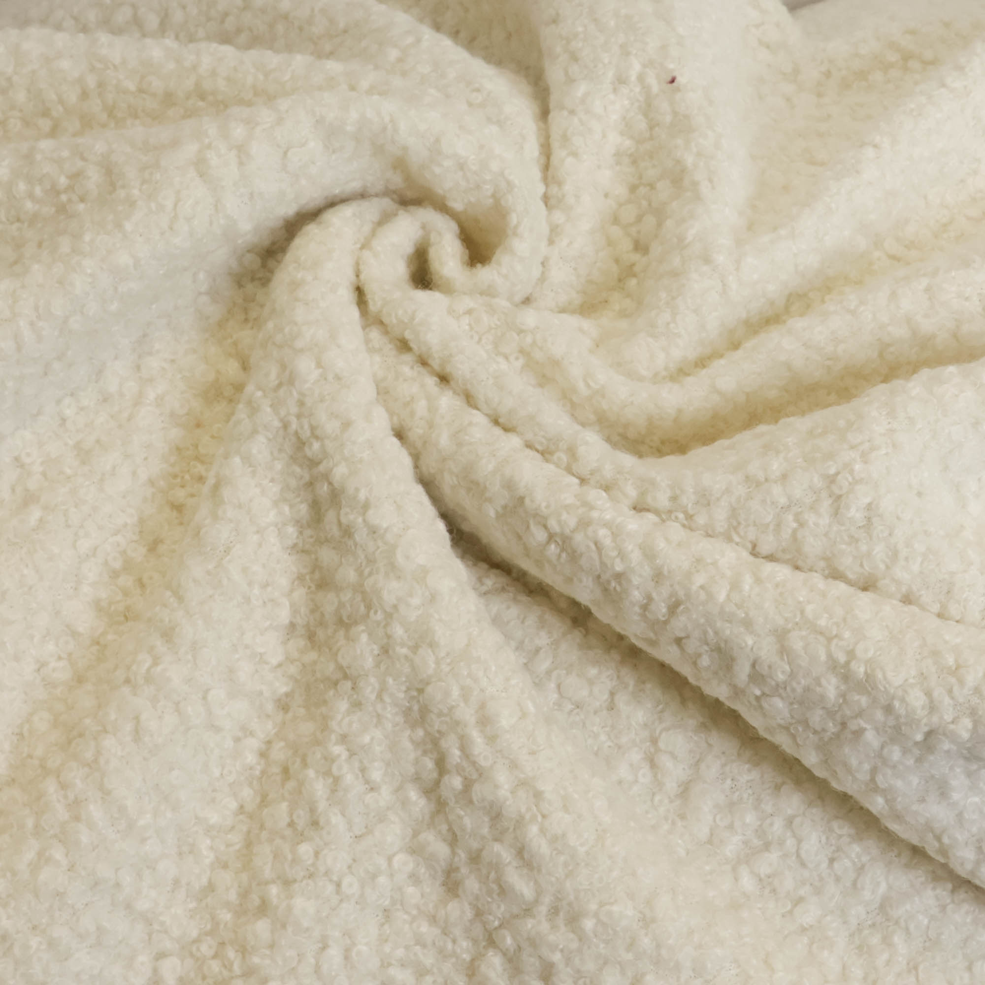 Bouclé stof effen gebroken wit