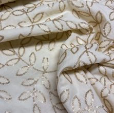 Katoen gebroken wit met bronze pailletten blaadjes