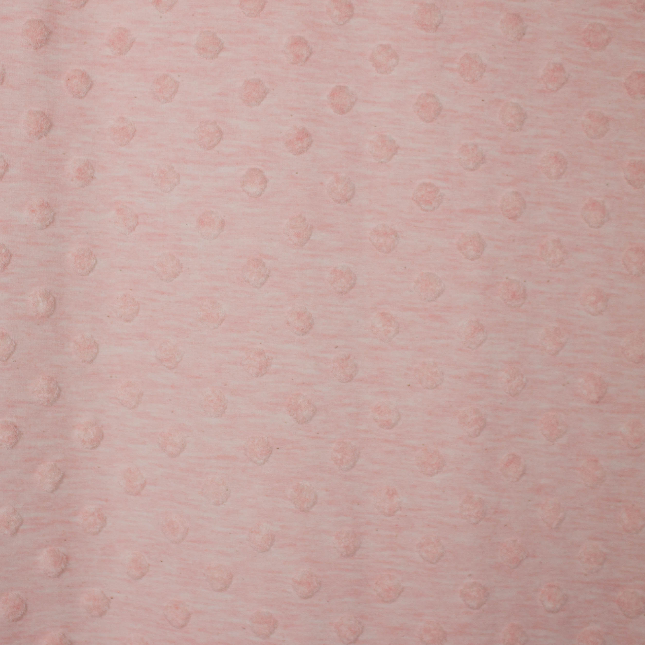 Roze tricot met dotjes bovenop de stof