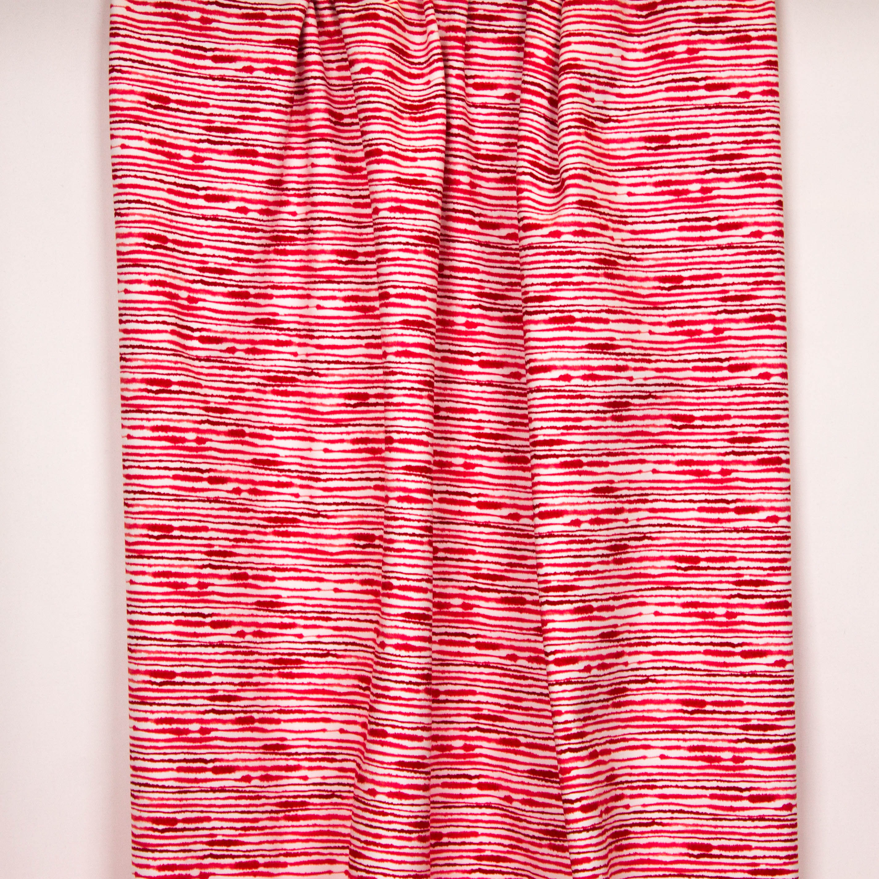 Witte tricot met rode onregelmatige strepen