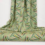 Licht groene french terry met blauwe, oranje, peach strepen van Poppy